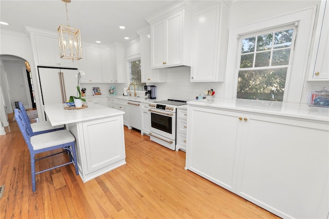 kitchen with white cabinetry, white appliances, and decorative backsplash