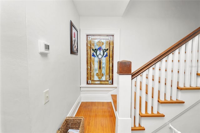 stairs featuring hardwood / wood-style floors