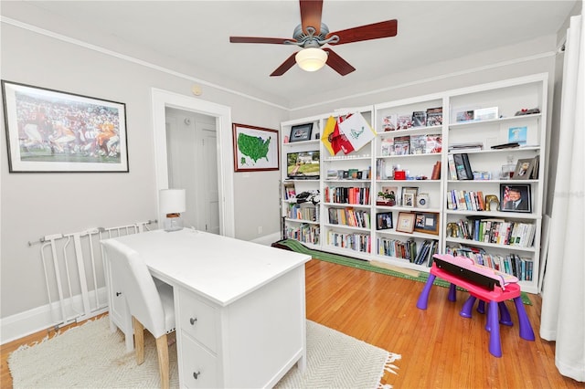 home office with ceiling fan, ornamental molding, and light hardwood / wood-style floors