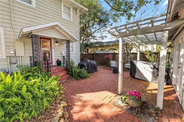 view of patio with a grill and a pergola