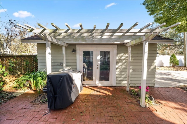 view of patio featuring french doors, area for grilling, and a pergola