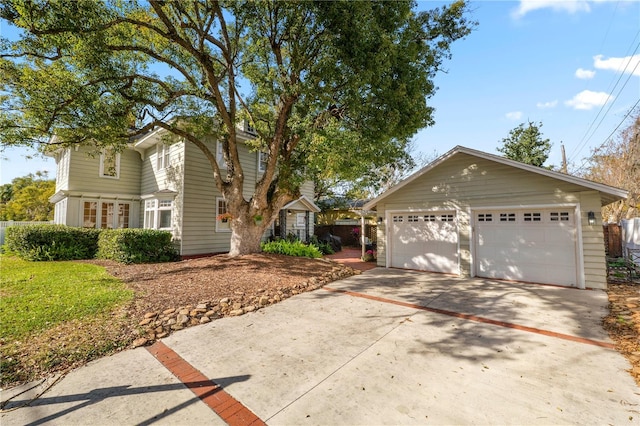 view of property with a garage and an outdoor structure