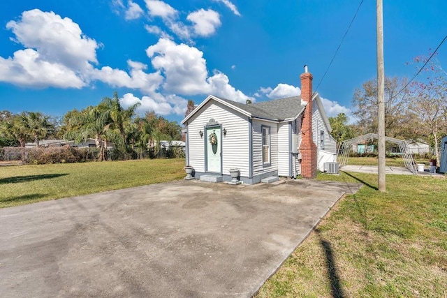 exterior space featuring a yard and central AC unit