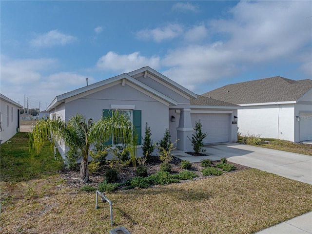 view of front of property featuring a garage and a front yard