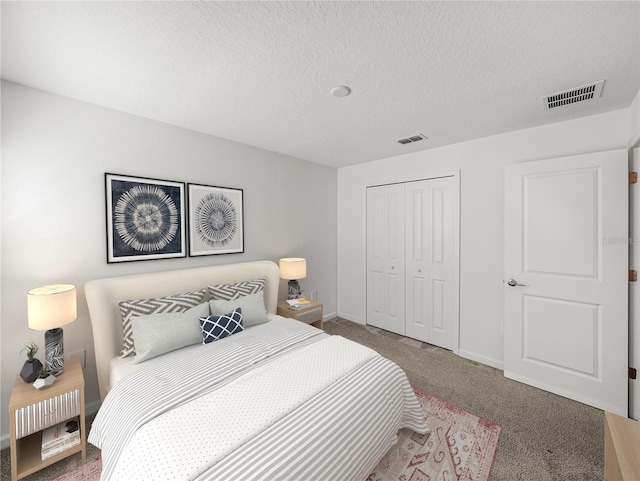 carpeted bedroom with a textured ceiling and a closet