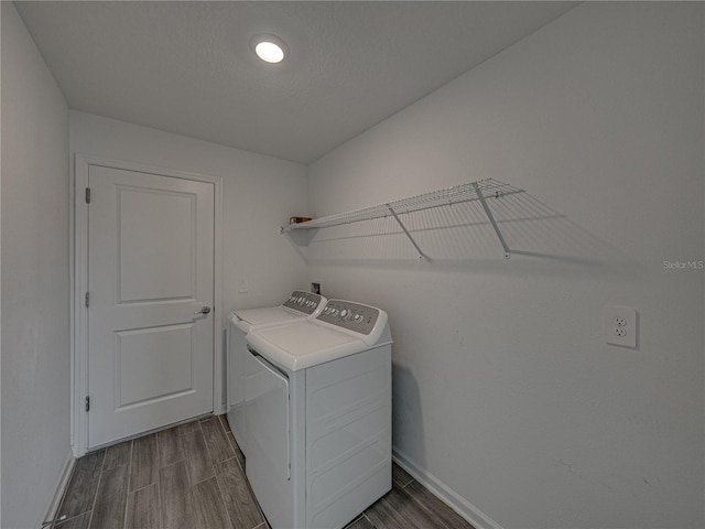 laundry area featuring separate washer and dryer and a textured ceiling