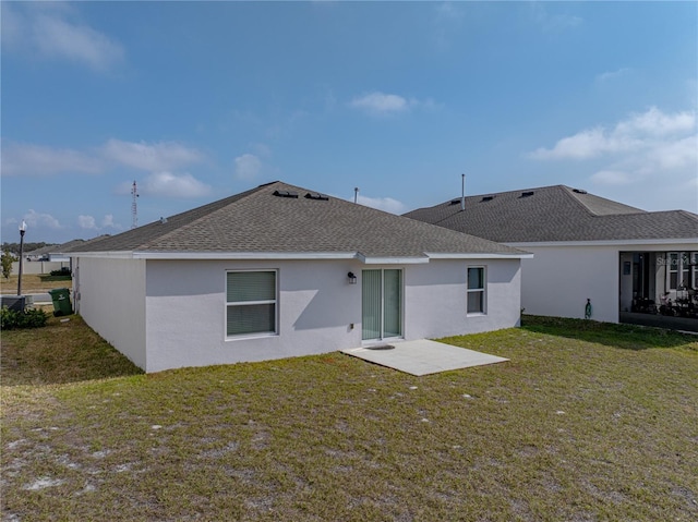 rear view of house with a patio area and a lawn