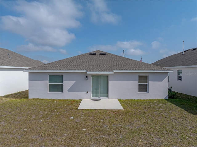 rear view of house featuring a patio and a yard