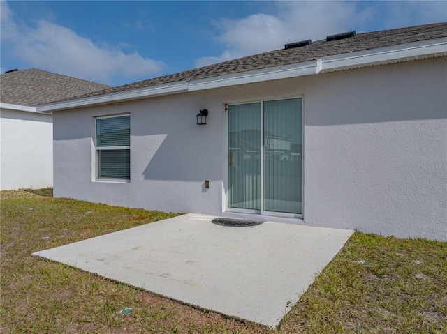 back of property featuring a yard and a patio area