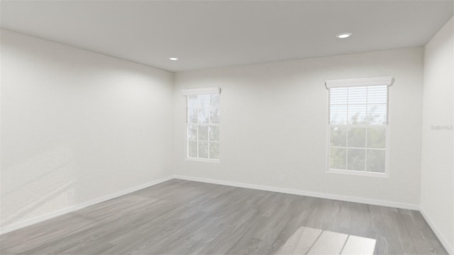 unfurnished room with light hardwood / wood-style floors