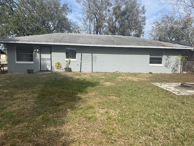 rear view of property with a yard