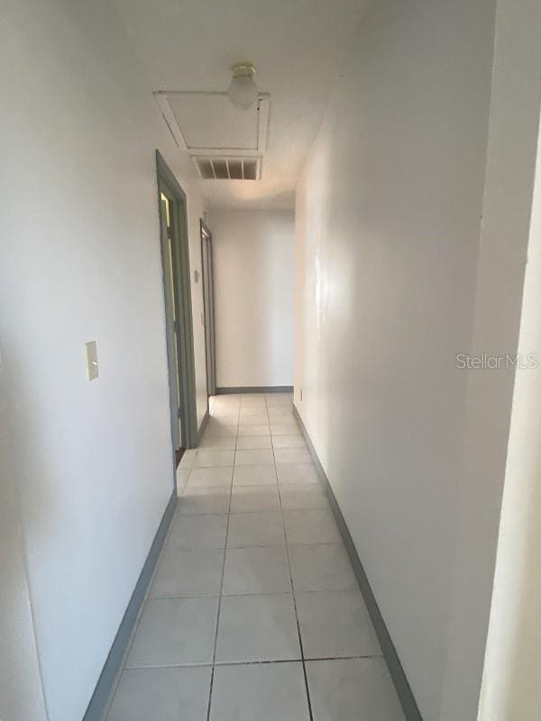 hall with light tile patterned floors