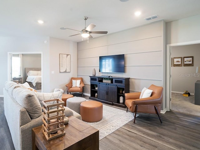 living room featuring hardwood / wood-style flooring and ceiling fan