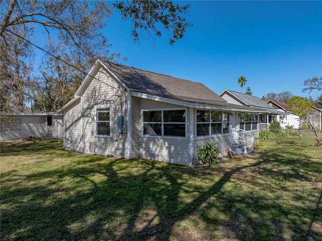 rear view of house featuring a yard