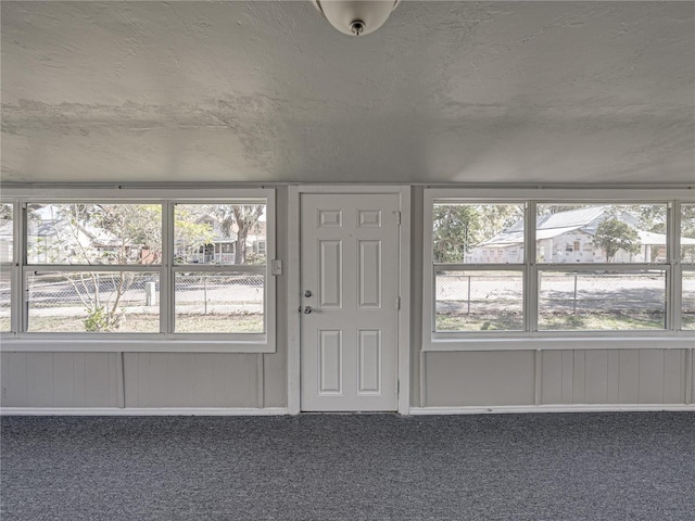 interior space with plenty of natural light and a textured ceiling