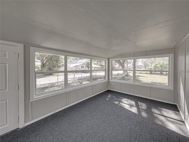 unfurnished sunroom with a wealth of natural light and vaulted ceiling