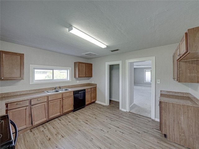 kitchen with sink, range, plenty of natural light, black dishwasher, and light wood-type flooring