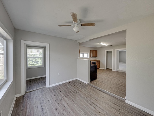 interior space with light hardwood / wood-style floors and ceiling fan