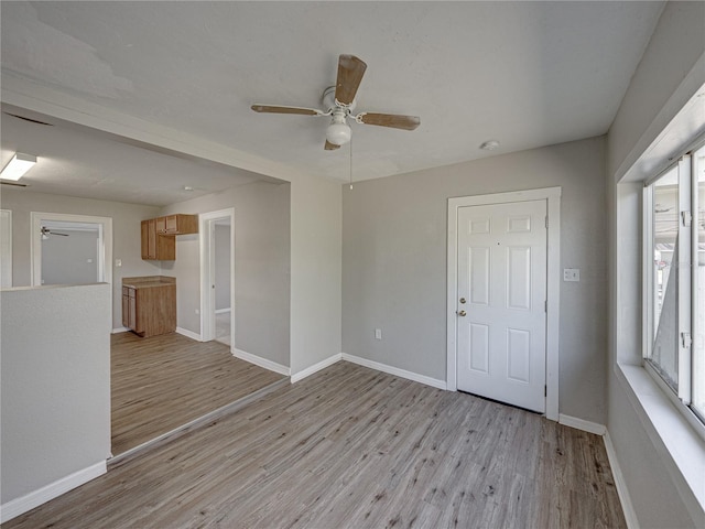 unfurnished room featuring ceiling fan and light wood-type flooring