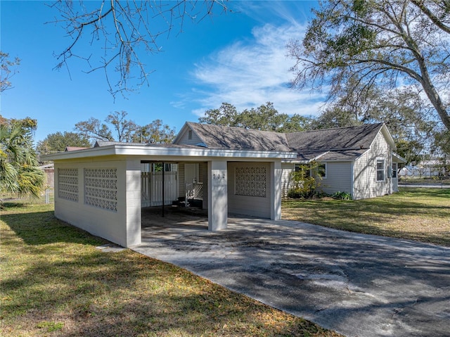 single story home with a front yard and a carport