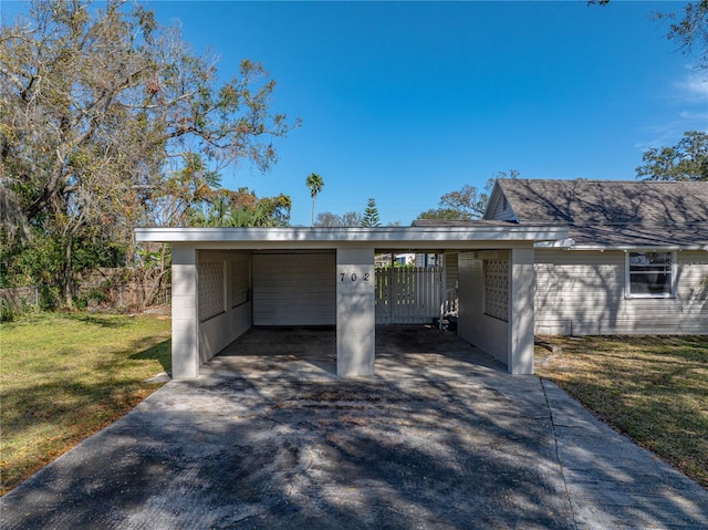 exterior space featuring a lawn and a carport