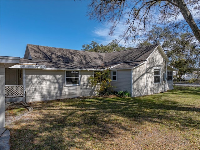 back of property featuring a lawn