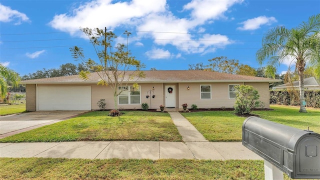 single story home featuring a garage and a front lawn