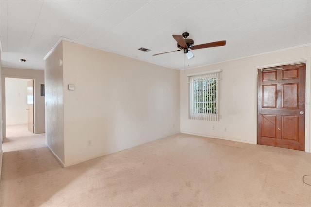 carpeted empty room with crown molding and ceiling fan