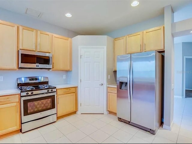 kitchen featuring appliances with stainless steel finishes and light brown cabinets