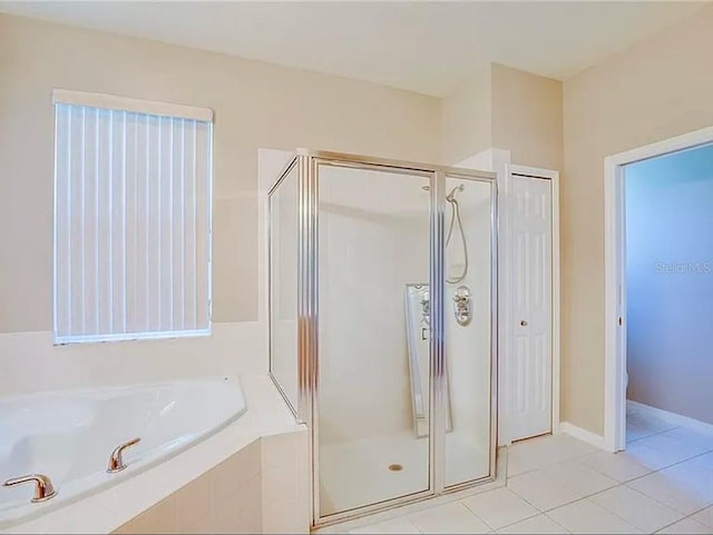 bathroom featuring tile patterned floors and shower with separate bathtub