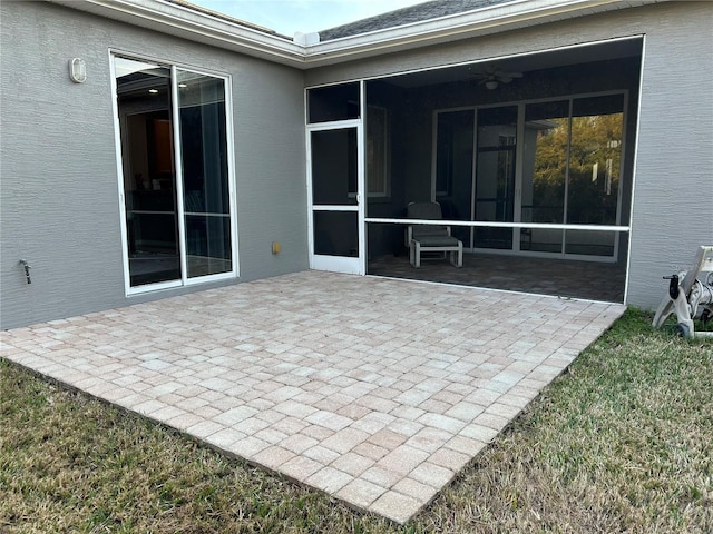 view of patio / terrace featuring a sunroom