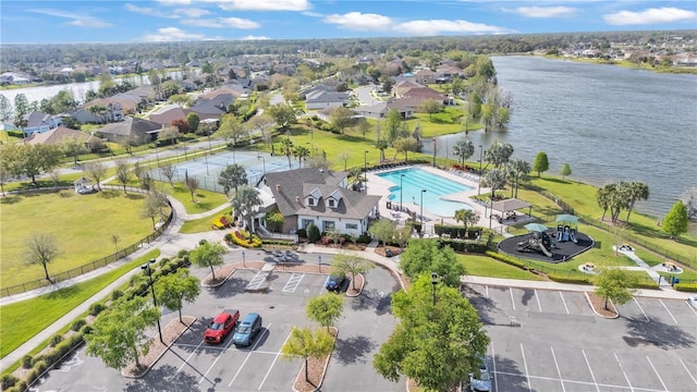 drone / aerial view featuring a water view and a residential view