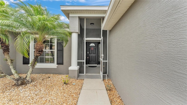 entrance to property with stucco siding