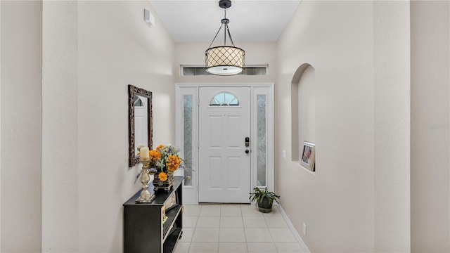 foyer featuring light tile patterned flooring and baseboards