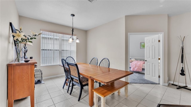 dining room featuring light tile patterned floors, baseboards, and a chandelier