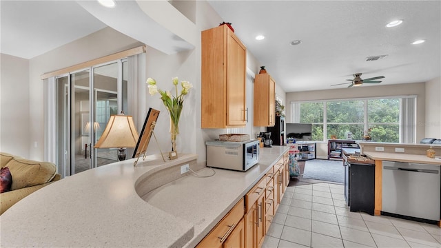 kitchen with stainless steel dishwasher, recessed lighting, visible vents, and open floor plan