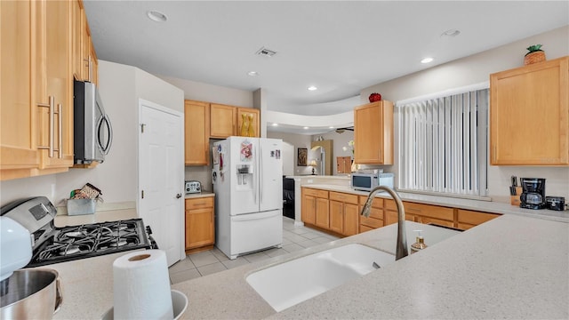 kitchen featuring visible vents, recessed lighting, appliances with stainless steel finishes, light tile patterned flooring, and a sink