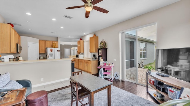 living room with a ceiling fan, light wood-style flooring, recessed lighting, and visible vents