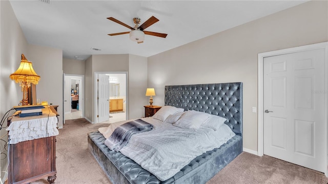 carpeted bedroom featuring visible vents, ceiling fan, ensuite bath, and baseboards