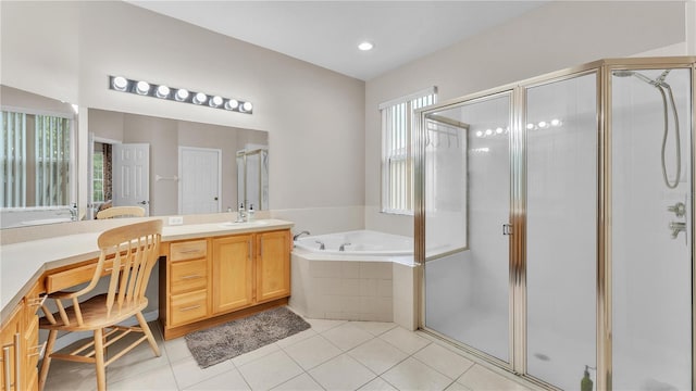 bathroom with a bath, tile patterned flooring, a shower stall, and vanity