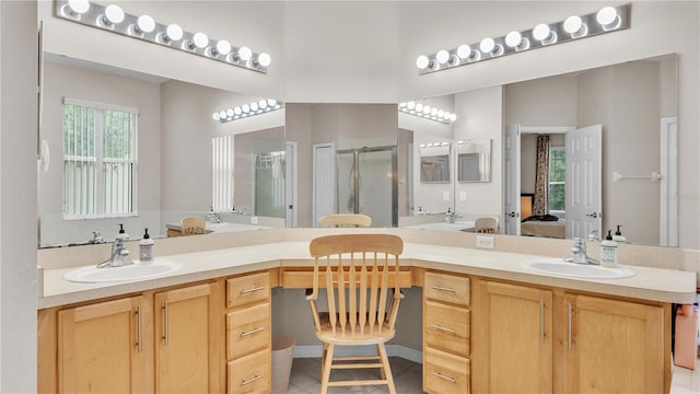 ensuite bathroom featuring a sink, connected bathroom, a shower stall, and tile patterned flooring