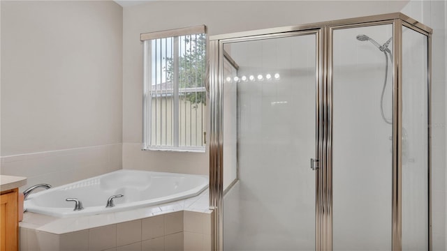 bathroom with vanity, a shower stall, and a bath