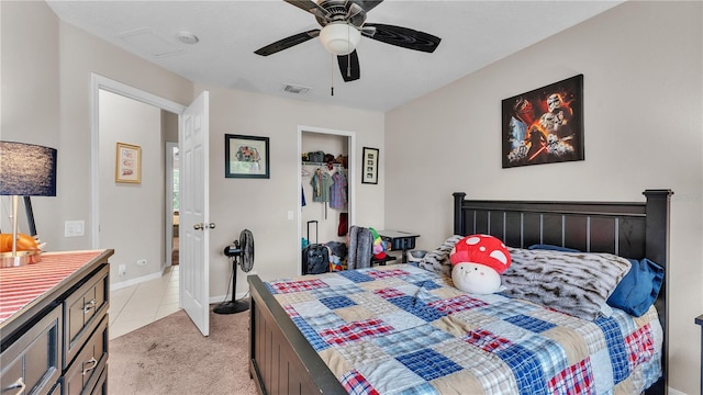 bedroom featuring light tile patterned floors, a ceiling fan, baseboards, visible vents, and light carpet