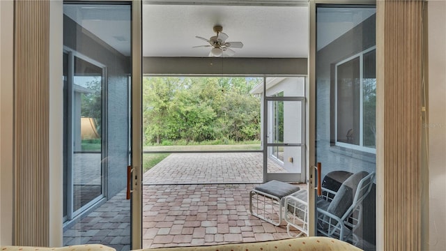 sunroom / solarium featuring ceiling fan