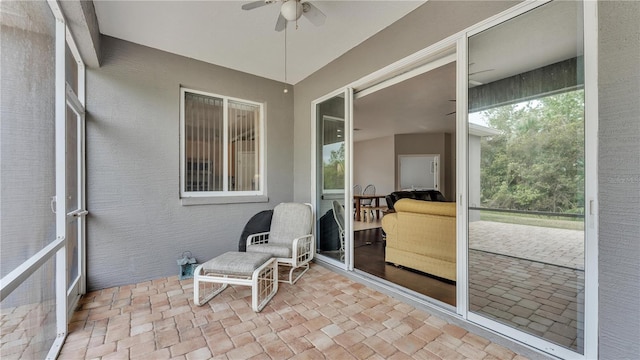 sunroom / solarium with a wealth of natural light and a ceiling fan