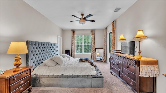 carpeted bedroom with ceiling fan and visible vents