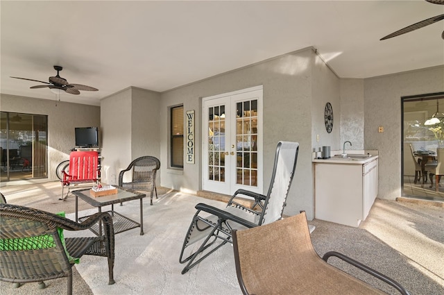 view of patio with french doors, ceiling fan, and sink