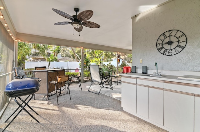 view of patio / terrace featuring area for grilling, a wet bar, and ceiling fan