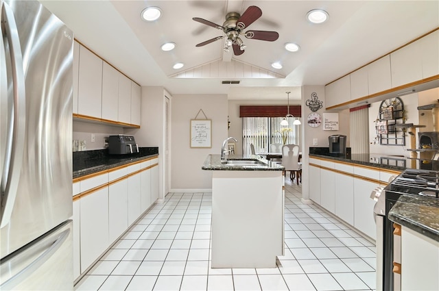 kitchen featuring light tile patterned flooring, appliances with stainless steel finishes, pendant lighting, sink, and white cabinets