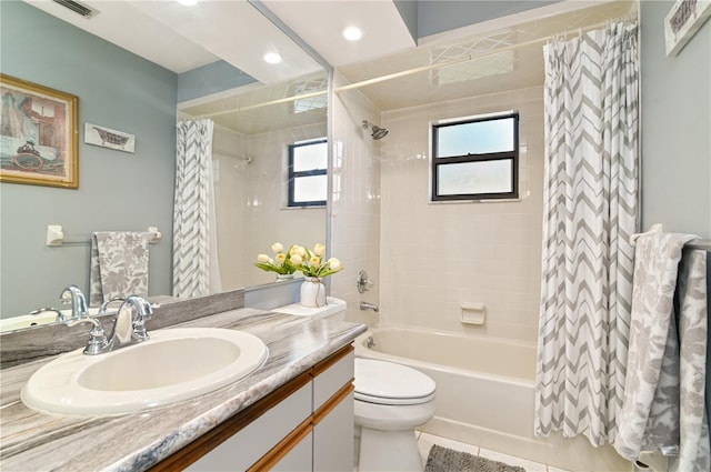 full bathroom with vanity, shower / tub combo, and toilet